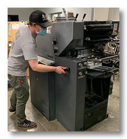 Jordan works on the Heidelberg Printmaster